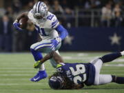 Dallas Cowboys running back Ezekiel Elliott (21) runs near Seattle Seahawks cornerback Shaquill Griffin (26) during the second half of the NFC wild-card NFL football game in Arlington, Texas, Saturday, Jan. 5, 2019.