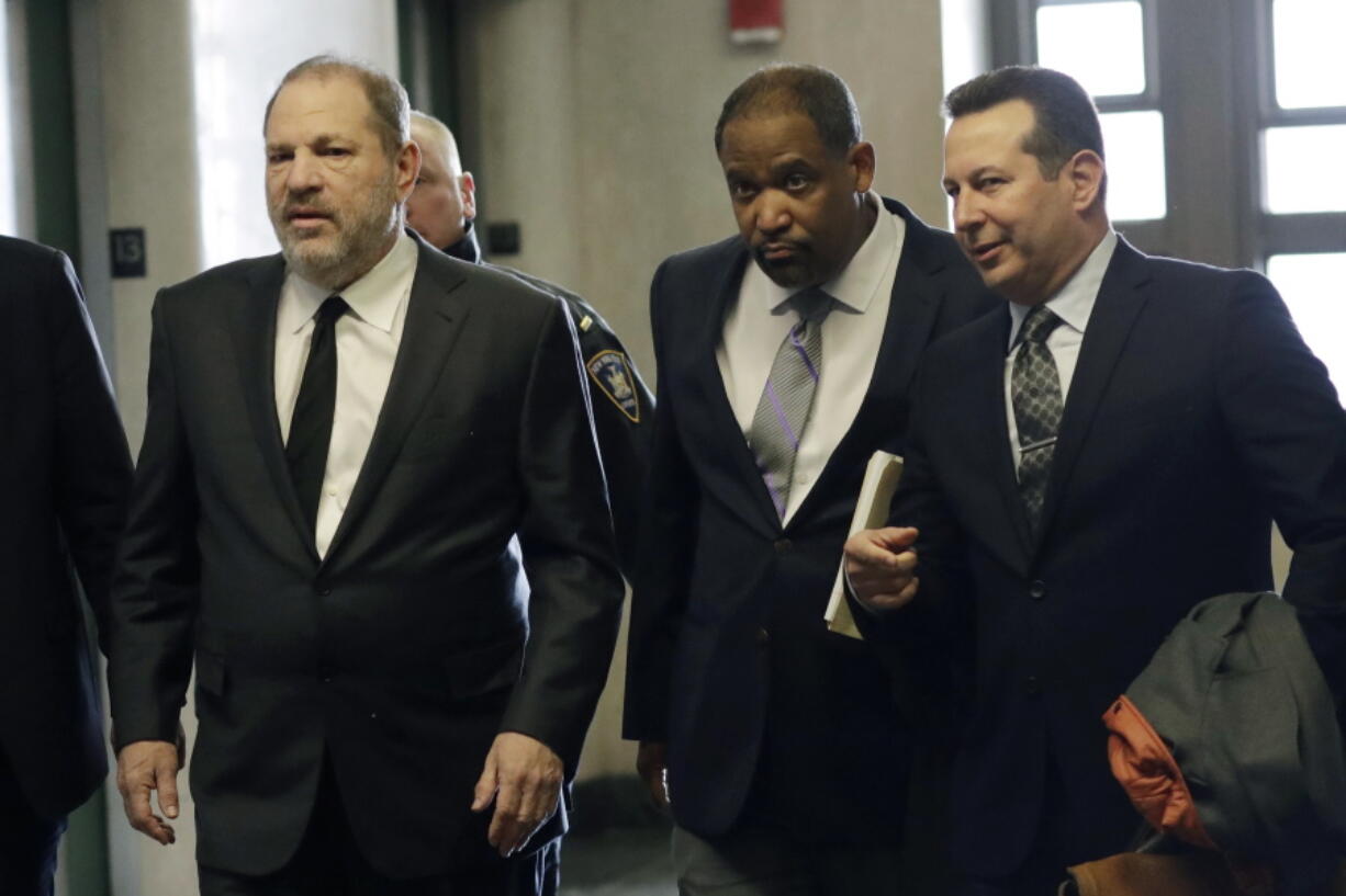 Harvey Weinstein, left, enters court with attorneys Ron Sullivan, center, and Jose Baez, Friday, Jan. 25, 2019, in New York.