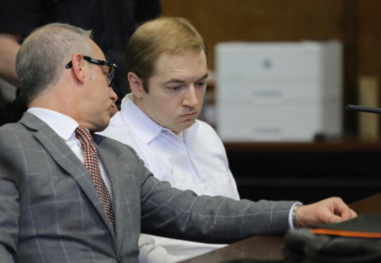 James Jackson, right, confers with his lawyer during a hearing in criminal court, Wednesday Jan. 23, 2019 in New York. Jackson, a white supremacist, pled guilty Wednesday, to killing a black man with a sword as part of a racist plot that prosecutors described as a hate crime. He faces life in prison when he is sentenced on Feb. 13.