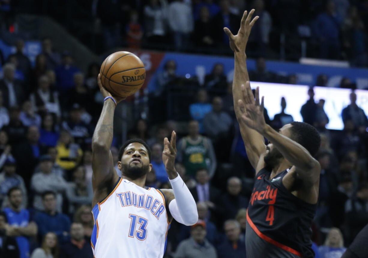 Oklahoma City Thunder forward Paul George (13) shoots in front of Portland Trail Blazers forward Maurice Harkless (4) in the first half of an NBA basketball game in Oklahoma City, Tuesday, Jan. 22, 2019.