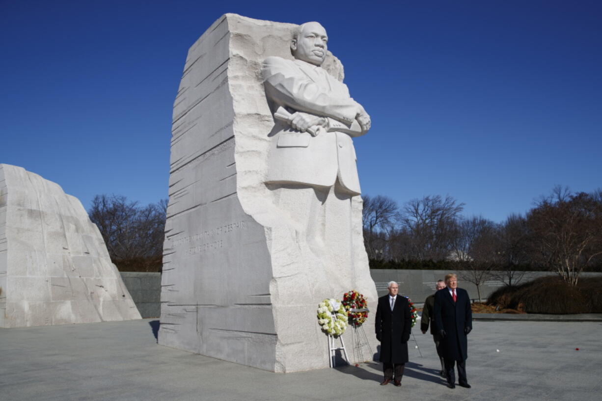 President Donald Trump, right, and Vice President Mike Pence, left, visit the Martin Luther King Jr. Memorial, Monday, Jan. 21, 2019, in Washington.