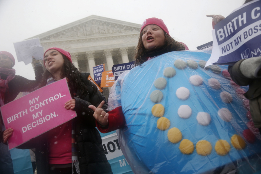 FILE - In this March 25, 2015 file photo, Margot Riphagen of New Orleans, La., wears a birth control pills costume during a protest in front of the U.S. Supreme Court in Washington. A U.S. judge will hear arguments Friday, Jan. 11, 2019, over California’s attempt to block new rules by the Trump administration that would allow more employers to opt out of providing no-cost birth control to women. The new rules are set to go into effect on Monday, Jan. 14, 2019.