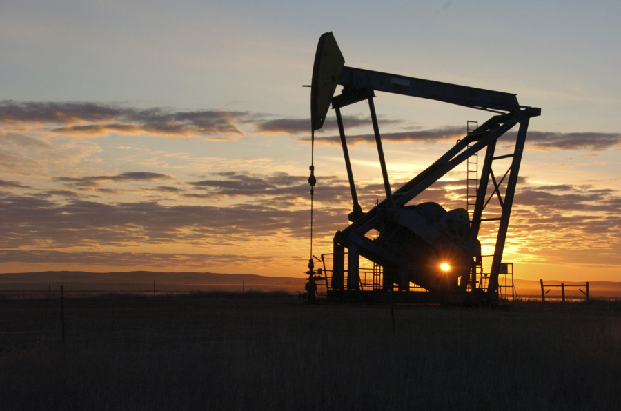 A Whiting Petroleum Co. pump jack pulls crude oil from the Bakken region of the Northern Plains on Nov. 6, 2013, near Bainville, Mont.