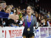 Alysa Liu greets fans while wearing her gold medal after winning the women’s title at the U.S. Figure Skating Championships, Friday, Jan. 25, 2019, in Detroit.