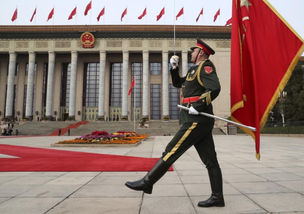 FILE - In this Nov. 9, 2017, file photo, a member of the Chinese military marches before the welcoming ceremony for President Donald Trump and Chinese President Xi Jinping at the Great Hall of the People, in Beijing, China. A new defense intelligence assessment lays out U.S.