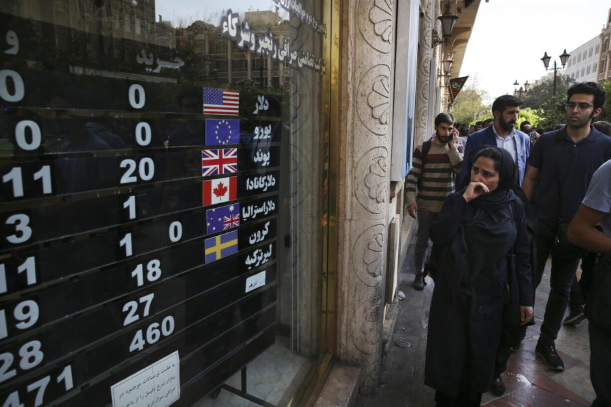 FILE - In this Oct. 2, 2018, file photo, an exchange shop displays rates for various currencies, in downtown Tehran, Iran. The Trump administration is closely eyeing efforts in Europe to set up an alternative money payment channel to ease doing business with Iran and avoid running afoul of sanctions the U.S. has levied on the Islamic republic.