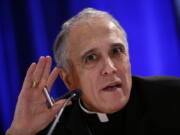 FILE - In this Nov. 12, 2018 file photo, Cardinal Daniel DiNardo of the Archdiocese of Galveston-Houston, president of the United States Conference of Catholic Bishops, listens to a reporter’s question during a news conference during the USCCB’s annual fall meeting, in Baltimore. When Cardinal DiNardo told a stunned meeting of U.S. bishops that the Vatican wouldn’t let them adopt new measures to address clergy sex abuse, he said the Holy See wanted them to wait until after a February abuse prevention summit called by Pope Francis. But a letter from the Vatican’s Cardinal Marc Oullet, obtained this week by The Associated Press, said the main reason the Vatican objected to the November vote was because U.S. bishops had withheld the problematic texts from the Vatican until the last minute, and didn’t consult Rome in drafting them.