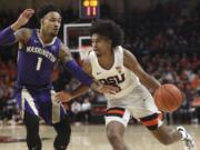 Oregon State's Ethan Thompson, right, is guarded by Washington's David Crisp (1) during the first half of an NCAA college basketball game in Corvallis, Ore., Saturday, Jan. 26, 2019.