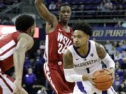 Washington guard David Crisp, right, drives around Washington State guard Viont’e Daniels, center, during the second half of an NCAA college basketball game, Saturday, Jan. 5, 2019, in Seattle. Washington won 85-67. (AP Photo/Ted S.