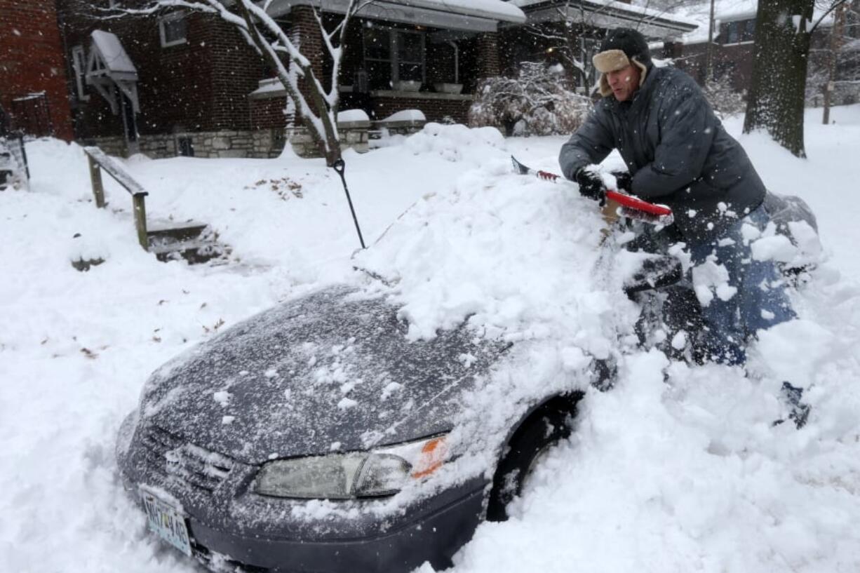 Jeff Clifford digs out his girlfriend's car from a pile of snow on Saturday, Jan. 12, 2019, in St. Louis. A winter storm swept the region this weekend, snarling traffic in several states and leaving thousands without power. (Laurie Skrivan/St.