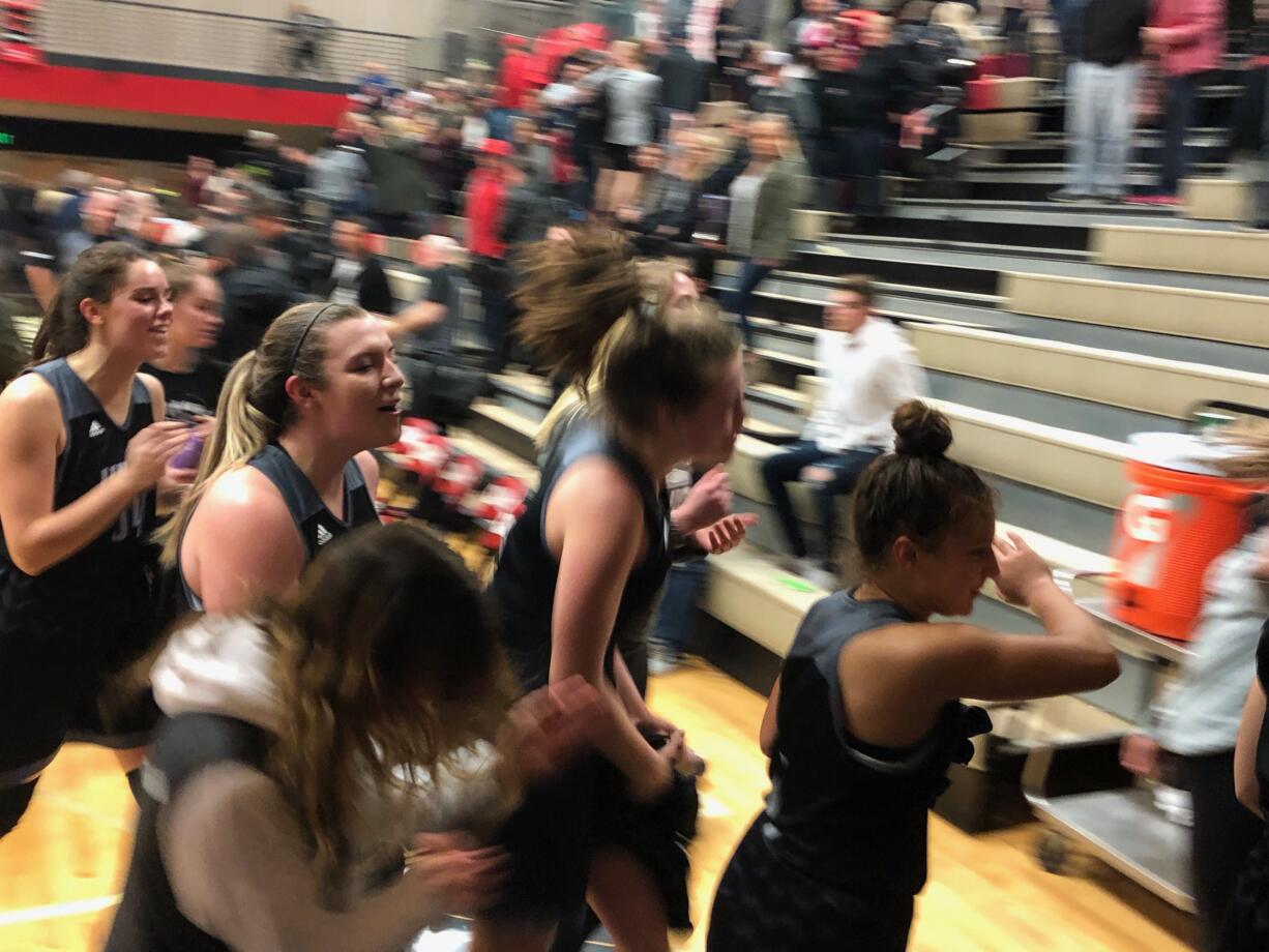 The Union girls basketball team celebrates while exiting the floor after a 53-44 win at Camas on Friday night.