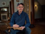 Bruce Sheridan with his journals in his home Jan. 18 in Oak Park, Ill. Sheridan, a musician and filmmaker, has kept journals regularly since childhood.