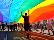 Parade participants march down Market Street carrying the rainbow flag in June 2013 during the annual Gay Pride parade in San Francisco.