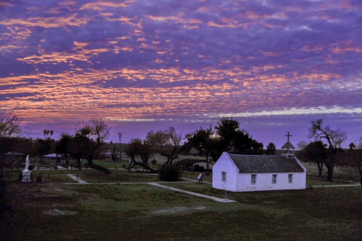 The sun sets behind La Lomita church in Mission, Texas, on Jan. 18. The modest sandstone chapel is caught between the coming fence — 18 feet high, made of steel bollards — and the Rio Grande, the dividing line between the U.S. and Mexico.