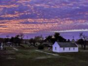 The sun sets behind La Lomita church in Mission, Texas, on Jan. 18. The modest sandstone chapel is caught between the coming fence — 18 feet high, made of steel bollards — and the Rio Grande, the dividing line between the U.S. and Mexico.