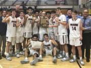 The Prairie boys basketball team celebrates its 3A bi-district tournament championship after beating Kelso 66-62 on Saturday, Feb. 16, 2019, at Puyallup High School.