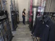 Administrative assistant Jean Ledgerwood looks through the assortment of fishing rods at Lamiglas in Woodland.