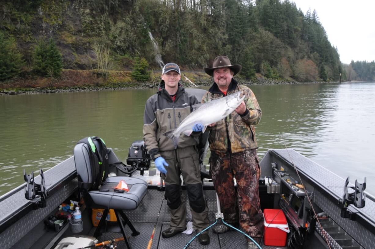 Bill Monroe, (left), and Buzz Ramsey with a nice spring Chinook taken in the lower Columbia River last year. The Columbia will close downstream of Warrior Rock on March 1 to protect depressed runs headed to the Lewis and Cowlitz Rivers.