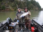 Bill Monroe, (left), and Buzz Ramsey with a nice spring Chinook taken in the lower Columbia River last year. The Columbia will close downstream of Warrior Rock on March 1 to protect depressed runs headed to the Lewis and Cowlitz Rivers.