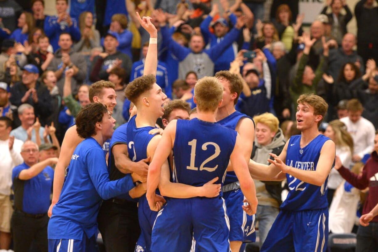 The La Center boys basketball team celebrates after beating King’s Way Christian in overtime Friday to capture the Trico League championship.