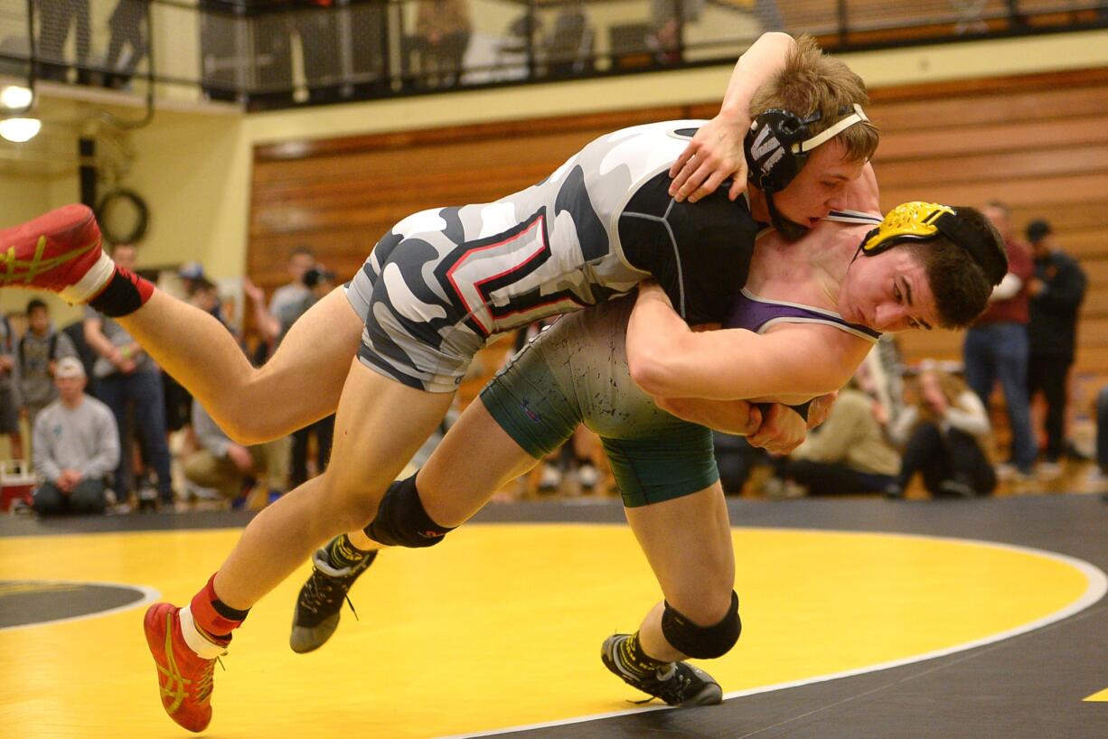 Union's Calvin Buck (left) wrestles Heritage's Alex Newberry in the 152-pound weight class during the 3A/4A district wrestling tournament at Hudson's Bay High School on Saturday, February 2, 2019.