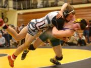 Union's Calvin Buck (left) wrestles Heritage's Alex Newberry in the 152-pound weight class during the 3A/4A district wrestling tournament at Hudson's Bay High School on Saturday, February 2, 2019.