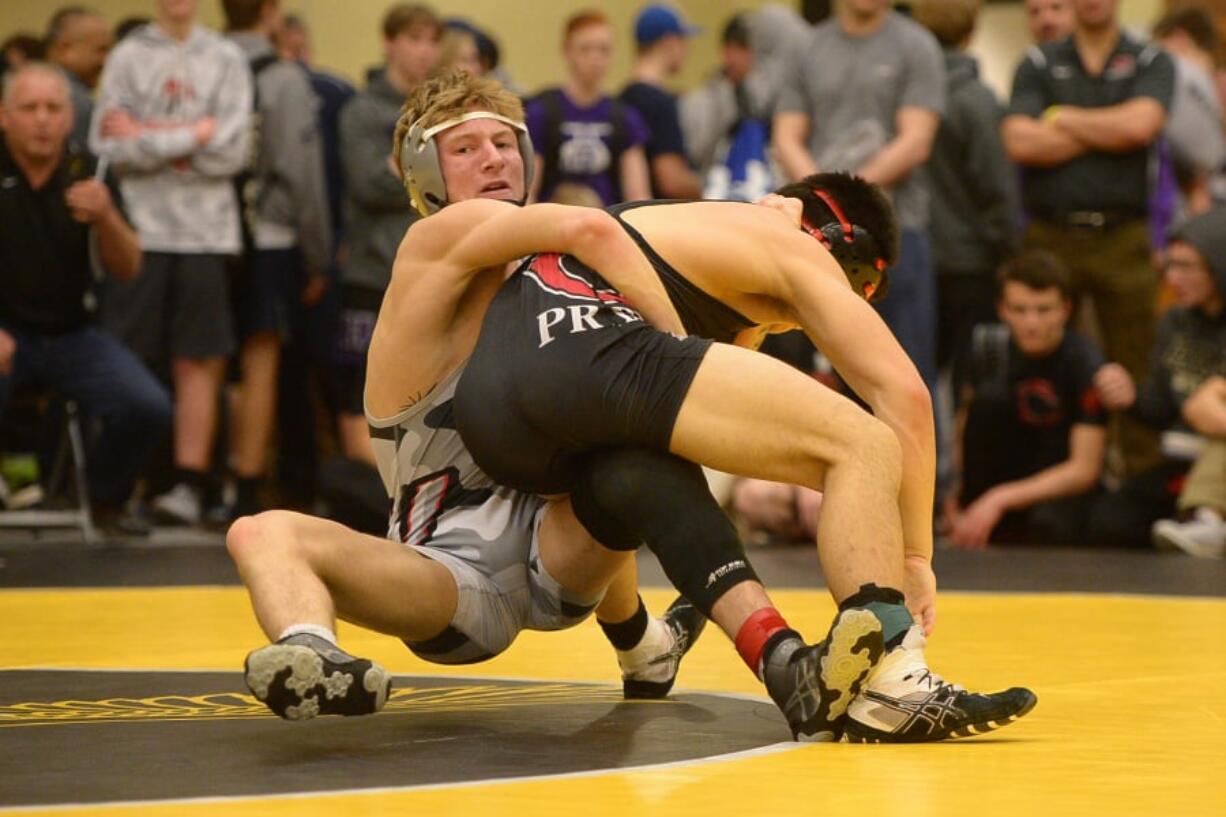 Union’s Noah Talavera defeats Camas’ Isaac Duncan in the 145-pound weight class during the 4A district wrestling tournament at Hudson’s Bay.