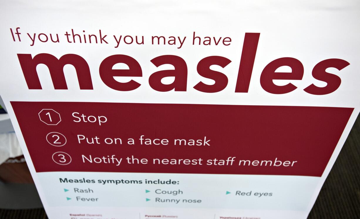 An informational sign about the measles is posted in the entrance of the Kaiser Permanente Cascade Park office Monday morning, Feb. 4, 2019.