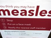 An informational sign about the measles is posted in the entrance of the Kaiser Permanente Cascade Park office Monday morning, Feb. 4, 2019.