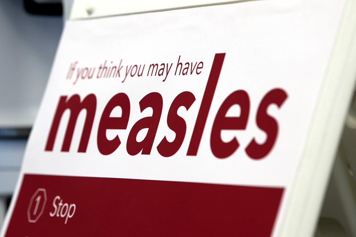 An informational sign about the measles is posted in the entrance of the Kaiser Permanente Cascade Park office Monday morning, Feb. 4, 2019.