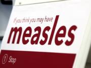 An informational sign about the measles is posted in the entrance of the Kaiser Permanente Cascade Park office Monday morning, Feb. 4, 2019.