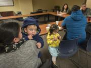 Above, Irene Cruz of Vancouver, from left, holds her baby, Nathan Pina, 1, while attending an education and support class for Spanish-speaking families who have children with developmental disabilities. The group began meeting in December.