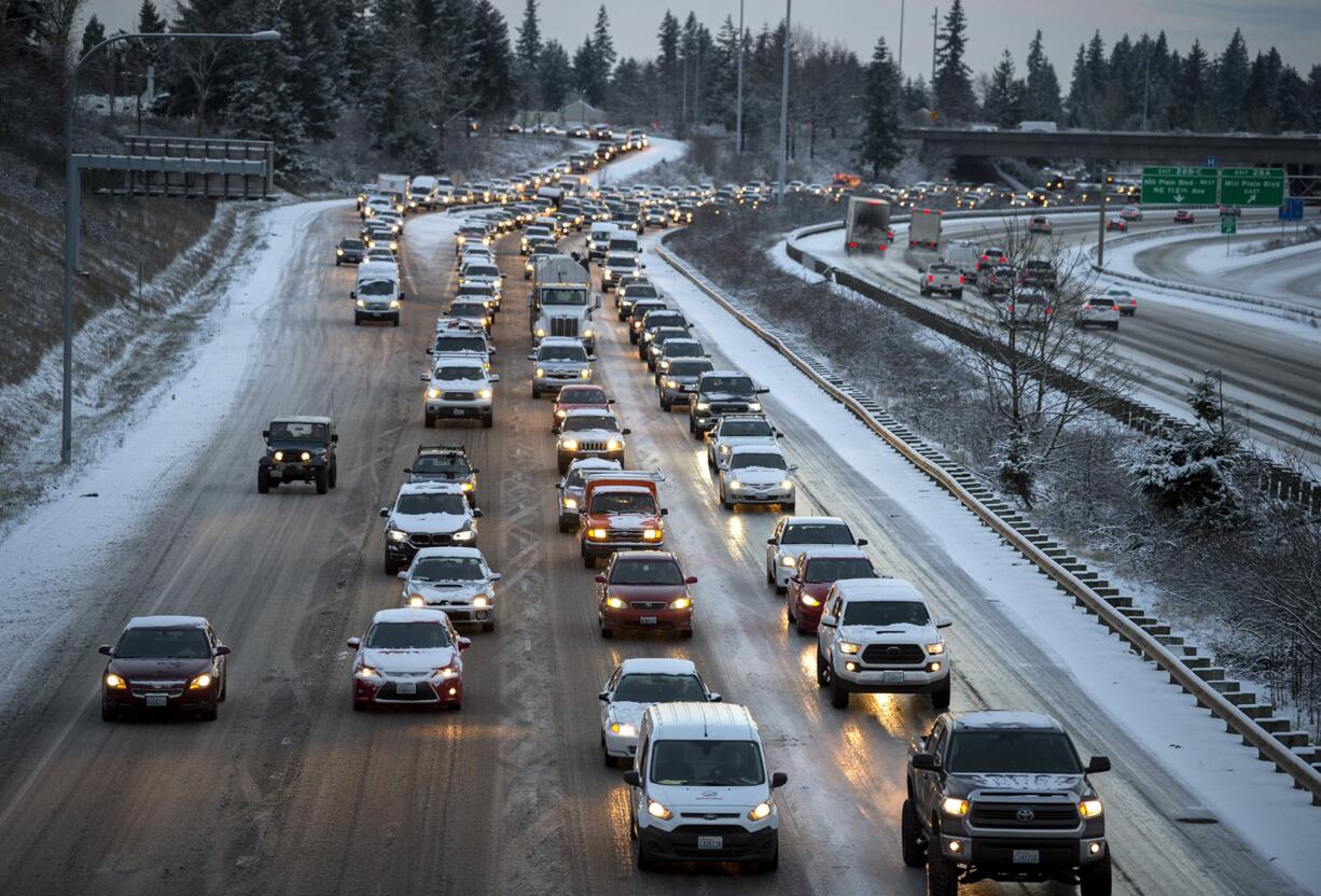 Southbound motorists move slowly along a slick Interstate 205 on Tuesday morning, Feb. 5, 2019 after snow blanketed the area overnight.