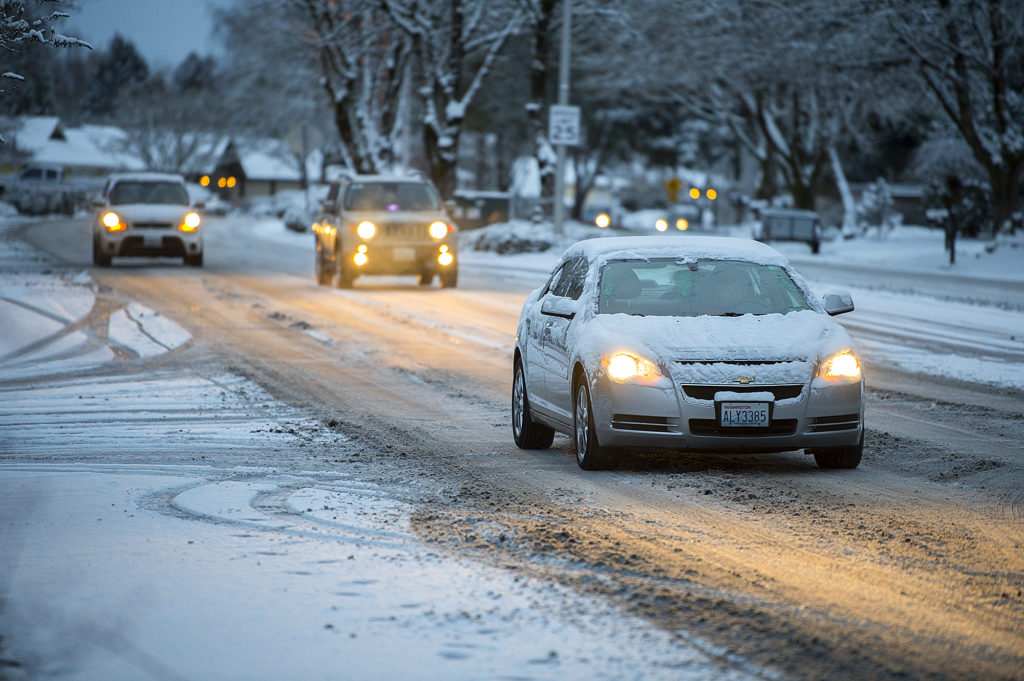 A snow-covered car drives through a slushy McGillivray Boulevard in Cascade Park on Tuesday morning, Feb. 5, 2019.