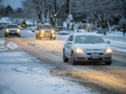 A snow-covered car drives through a slushy McGillivray Boulevard in Cascade Park on Tuesday morning, Feb. 5, 2019.