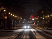 A motorist travels along an snowy Main Street in Vancouver on Monday night, Feb. 4, 2019.