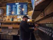 Ben Davenport, general manager, pours a beer at Thirsty Sasquatch in Vancouver on Feb. 5, 2018.