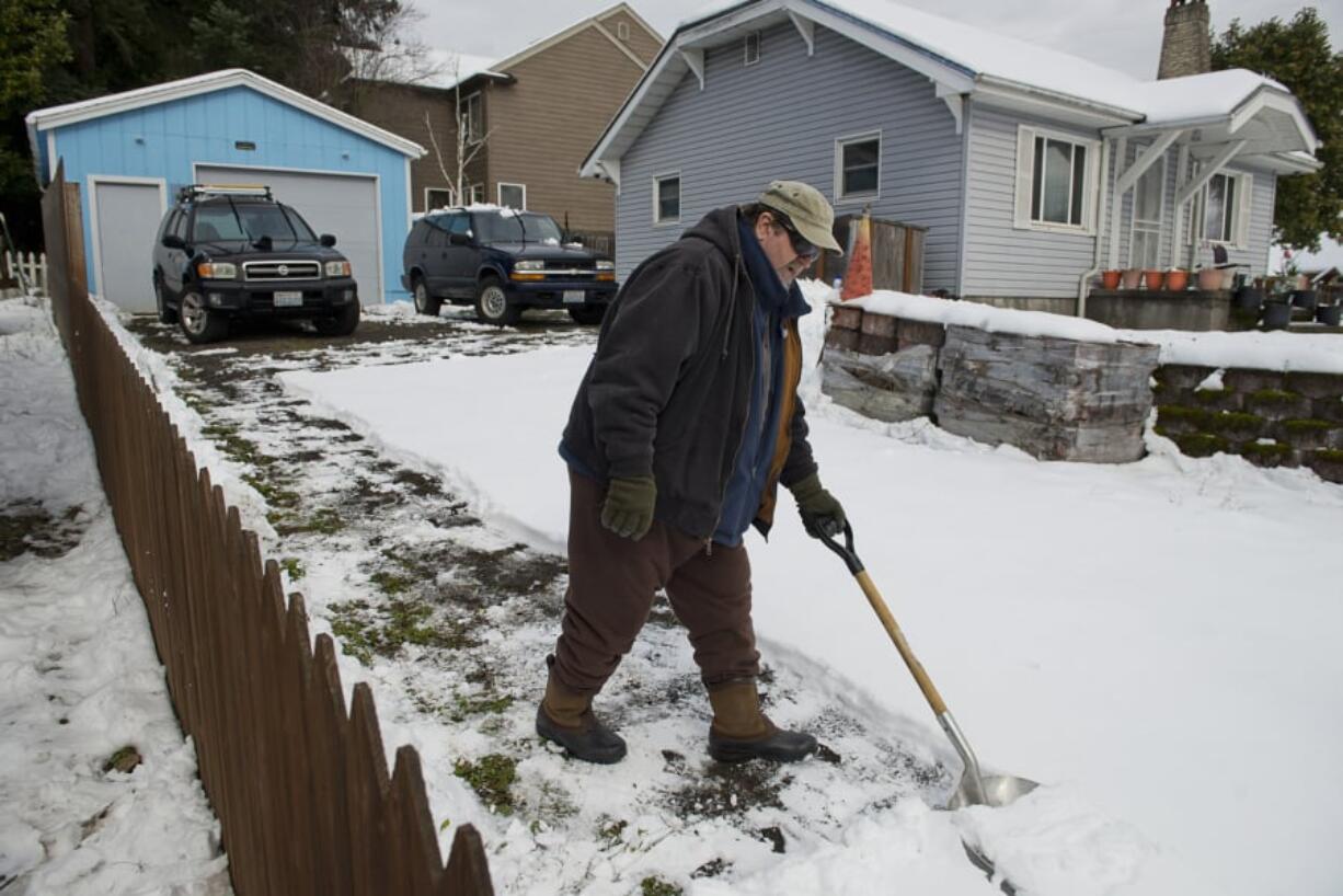 Paul Yates of Camas shovels his driveway Sunday before the workweek.