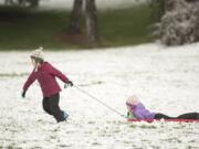 Ruby Ewing, 8, pulls sister Imogen, 6, on a sled at Franklin Park on Saturday.