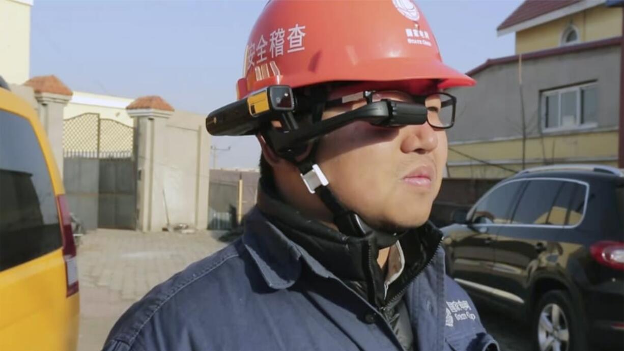 A State Grid worker looks at the screen on a RealWear HMT-1 headset.