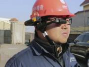 A State Grid worker looks at the screen on a RealWear HMT-1 headset.