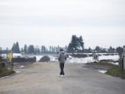 Mike Nelson of Vancouver walks to the entrance of the Section 30 gravel-mining site to get a better look. Residents near the site have raised concerns about a proposed compost facility that would operate inside this mining pit in east Vancouver.