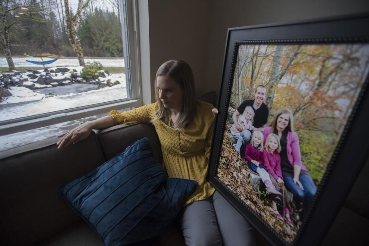 Alissa Parker, whose daughter Emilie was killed in the shooting at Sandy Hook Elementary School in Newtown, Conn., poses for a photo with a portrait of her family at her Clark County home. Parker has become an advocate for school safety since the death of her daughter, lobbying the Legislature and launching the Safe and Sound Schools initiative. Family members pictured are Samantha, Robbie, Alissa, Emilie and Madeline Parker.