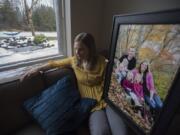 Alissa Parker, whose daughter Emilie was killed in the shooting at Sandy Hook Elementary School in Newtown, Conn., poses for a photo with a portrait of her family at her Clark County home. Parker has become an advocate for school safety since the death of her daughter, lobbying the Legislature and launching the Safe and Sound Schools initiative. Family members pictured are Samantha, Robbie, Alissa, Emilie and Madeline Parker.