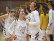 Prairie’s Cassidy Gardner, left, and Dayna Vera celebrate their victory over Lincoln following a game.