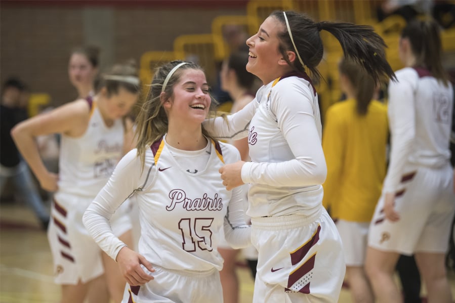 Prairie’s Cassidy Gardner, left, and Dayna Vera celebrate their victory over Lincoln following a game.