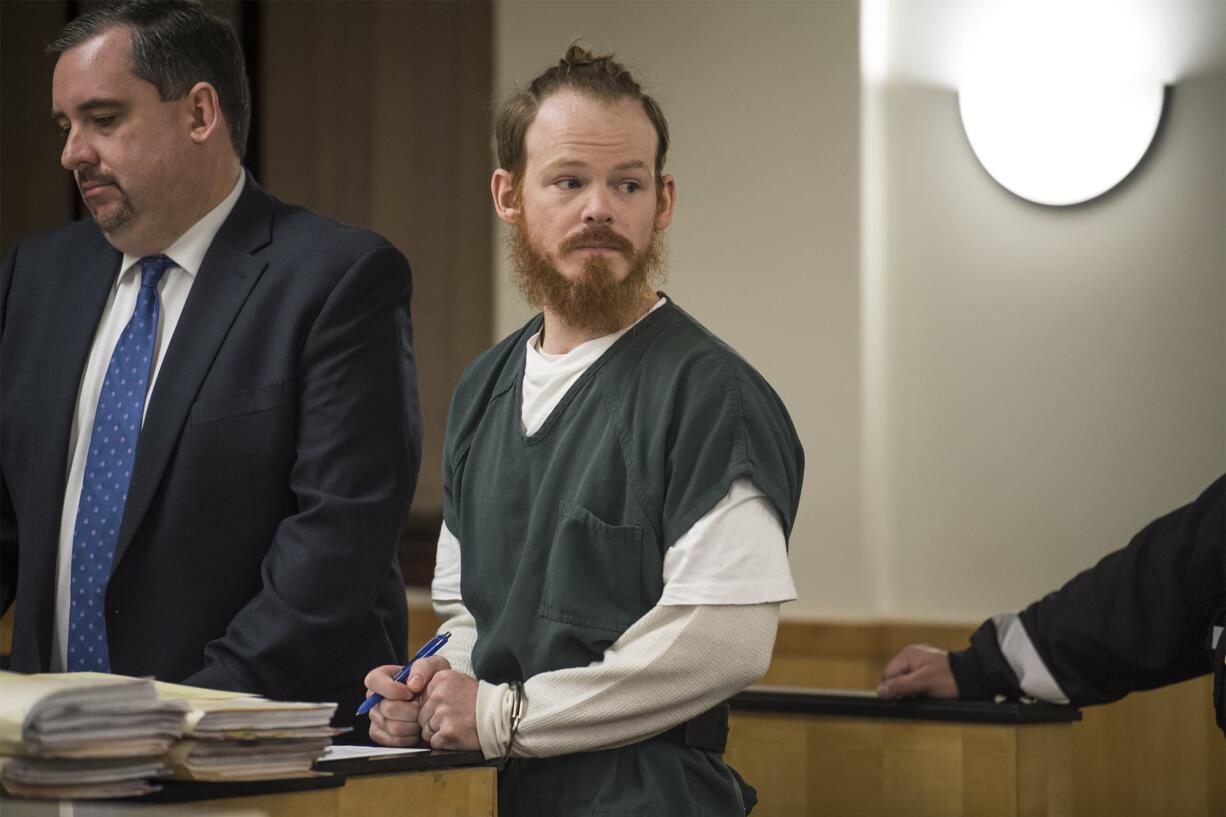 Christopher A. North signs paperwork following sentencing Monday afternoon, Feb. 11, 2019, in Clark County Superior Court. The former Clark County corrections deputy, who sexually assaulted two women detained at the Clark County Jail in 2017, was sentenced to nearly 31/2 years in prison.