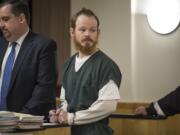 Christopher A. North signs paperwork following sentencing Monday afternoon, Feb. 11, 2019, in Clark County Superior Court. The former Clark County corrections deputy, who sexually assaulted two women detained at the Clark County Jail in 2017, was sentenced to nearly 31/2 years in prison.