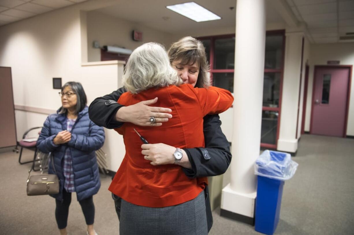 Tamara Shoup, interim executive director for school supports, center left, and Christina Iremonger, chief digital officer, hug in celebration after hearing election results at the Vancouver Public Schools district offices on Tuesday night. Both the educational fund and technology levies were passing with wide margins after initial results were released.