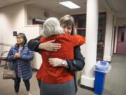 Tamara Shoup, interim executive director for school supports, center left, and Christina Iremonger, chief digital officer, hug in celebration after hearing election results at the Vancouver Public Schools district offices on Tuesday night. Both the educational fund and technology levies were passing with wide margins after initial results were released.